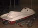 1994 Ford Bronco - A white and red personal watercraft sits on a trailer in what appears to be a garage or workshop.
